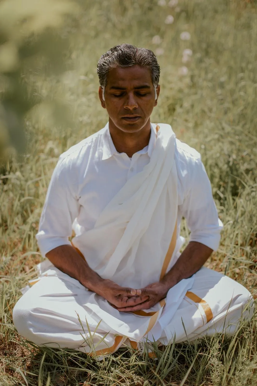 Akash Nair, yoga and meditation facilitator, seated in meditation